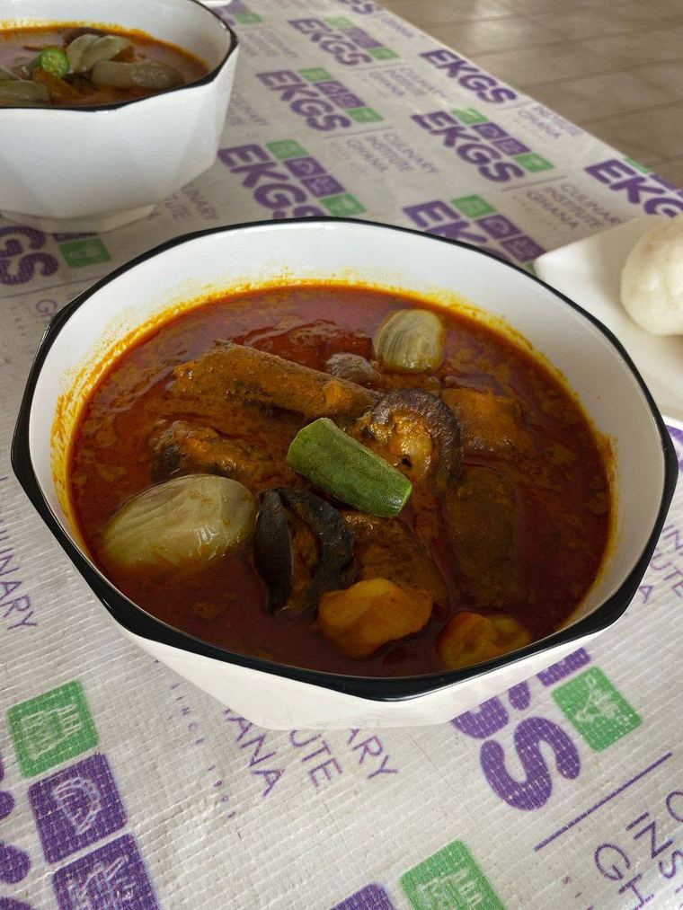 Bowl of Ghanaian soup with garden eggs and okra, served with fufu