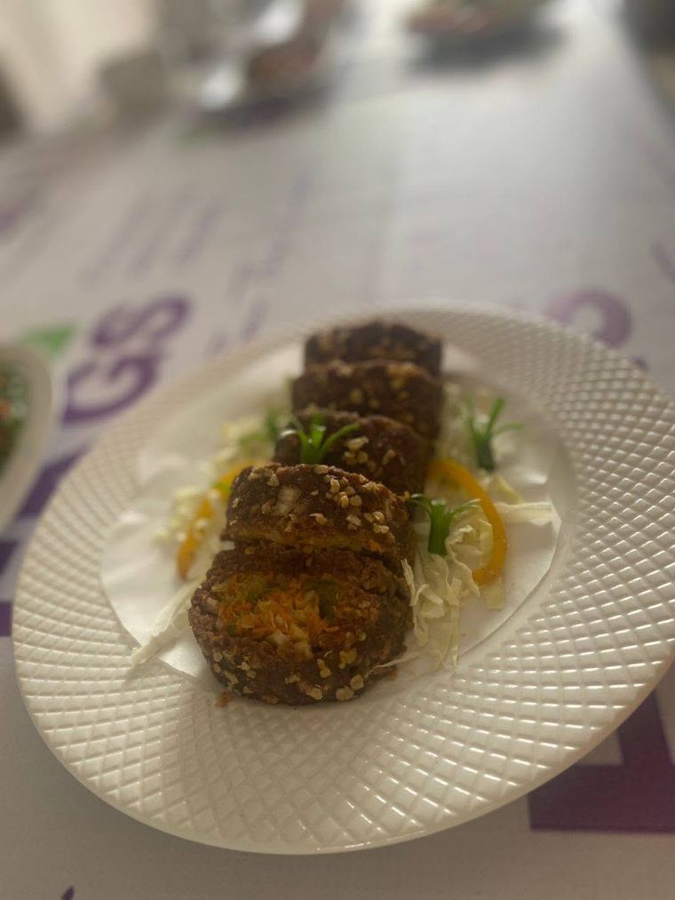Sliced crumb-coated rolls on shredded cabbage, made at EKGS