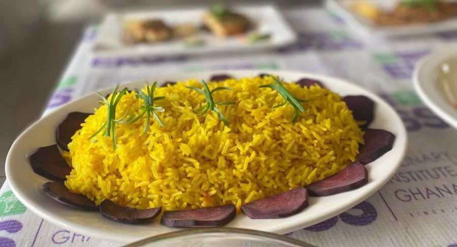 Yellow spiced rice garnished with rosemary and a ring of beetroot slices