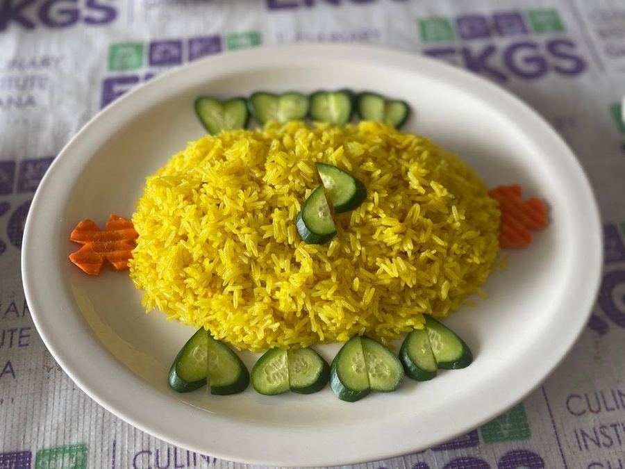 Yellow rice with carved cucumber and carrot garnish